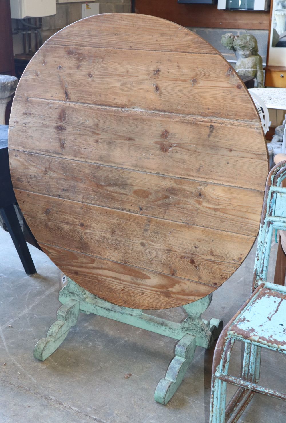 A 19th century Continental circular pine folding tilt top table, 104cm diameter, H.73cm